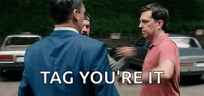 Two Men Are Standing Next To Each Other With The Words Tag You 'Re It On The Bottom GIF
