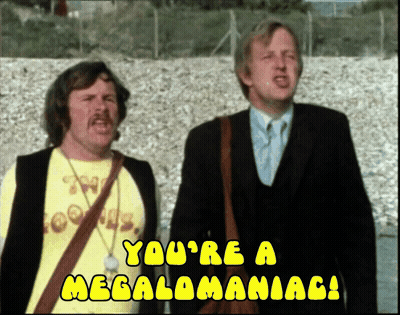 Two Men Are Standing Next To Each Other With The Words " You 'Re A Megalomaniac " On The Bottom GIF