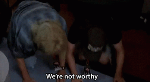 Two Men Are Standing Next To Each Other With Their Arms In The Air And One Of Them Is Saying `` We 'Re Not Worthy '' GIF