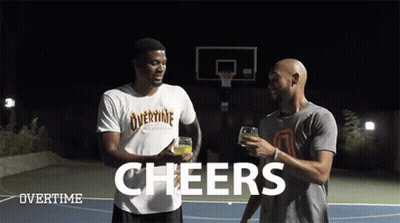 Two Men Are Standing On A Basketball Court With The Words Cheers Above Them GIF