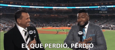 Two Men Are Talking In Front Of A Baseball Field And One Of Them Says El Que Perdió GIF