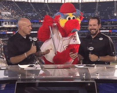 Two Men Are Talking To A Mascot Wearing A Fox Logo GIF