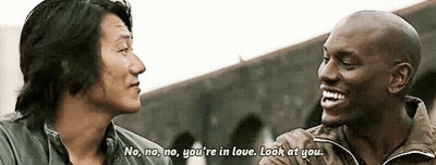 Two Men Are Talking To Each Other And One Of Them Is Laughing . GIF