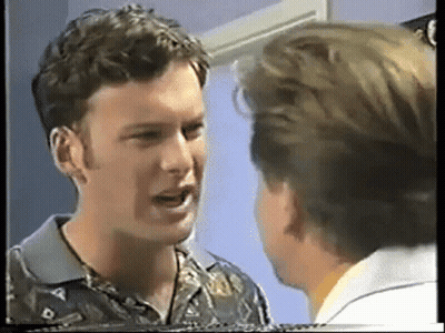 Two Men Are Talking To Each Other In A Room GIF