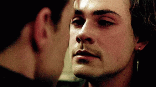 Two Men Are Touching Each Other 'S Faces In A Close Up Of Their Faces GIF