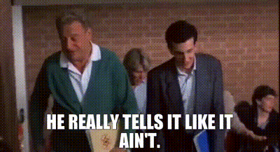 Two Men Are Walking Down A Hallway And One Of Them Is Saying `` He Really Tells It Like It Ain 'T '' GIF