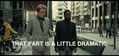Two Men Are Walking Down A Street With The Words That Part Is A Little Dramatic Behind Them GIF