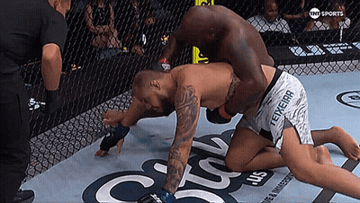 Two Men Are Wrestling In A Cage With The Words Tnt Sports On The Bottom Right GIF