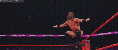 Two Men Are Wrestling In A Ring And One Of Them Is Laying On The Ground . GIF