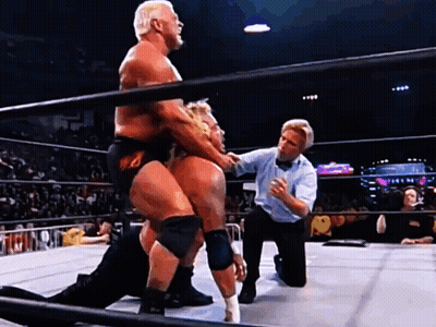 Two Men Are Wrestling In A Ring With A Referee GIF