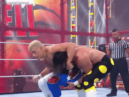 Two Men Are Wrestling In A Ring With A Referee In Front Of A Sign That Says ' Smackdown ' GIF