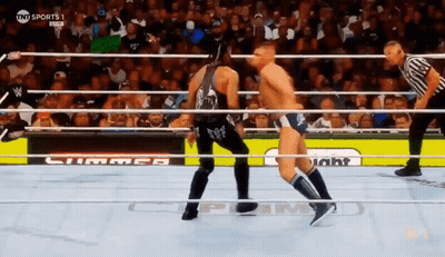 Two Men Are Wrestling In A Ring With A Sign That Says Tnt Sports GIF