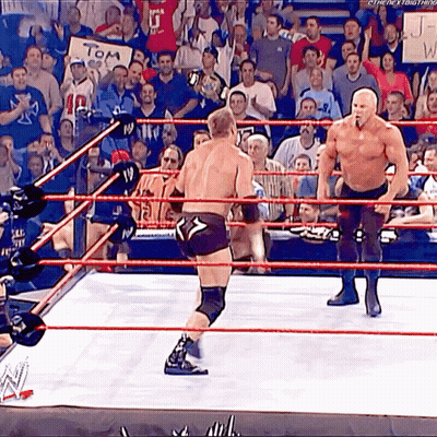 Two Men Are Wrestling In A Ring With A Sign That Says Tom GIF