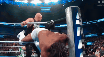 Two Men Are Wrestling In A Ring With A Sign That Says Wwe GIF