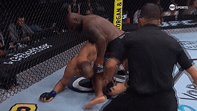 Two Men Are Wrestling In A Ring With A Yellow Sign That Says Morgan & Organ GIF