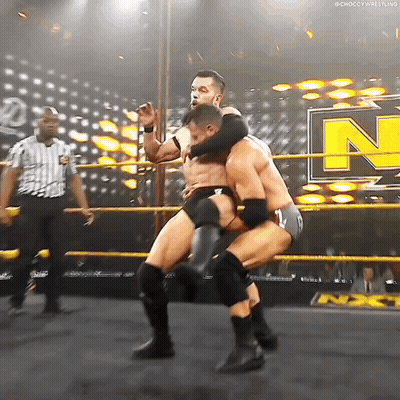 Two Men Are Wrestling In A Ring With The Letter N On The Side GIF