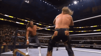 Two Men Are Wrestling In A Ring With The Word Full On The Stands GIF