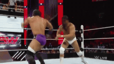 Two Men Are Wrestling In A Wrestling Ring And The Words W Live Are On The Screen GIF