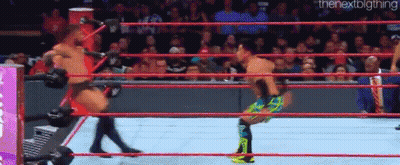 Two Men Are Wrestling In A Wrestling Ring . GIF
