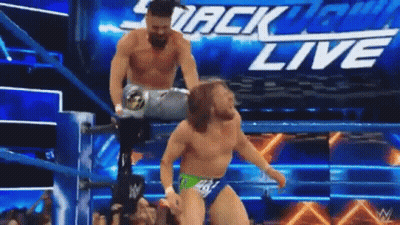 Two Men Are Wrestling In A Wrestling Ring With The Words Smackdown Live On The Bottom GIF