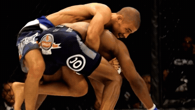 Two Men Are Wrestling With One Wearing Shorts That Say 20 GIF