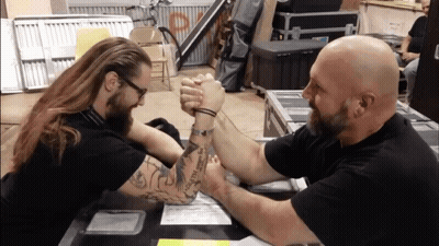 Two Men Arm Wrestling With I Love You Tattoo