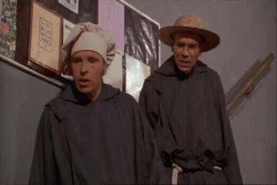 Two Men At Bulletin Board With Man In Hat GIF