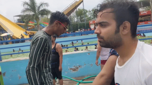 Two Men At Coca Cola Water Park Sign GIF
