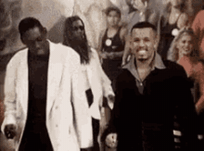 Two Men At Party With Crowd GIF