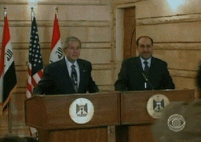 Two Men At Podiums With Flags GIF
