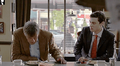 Two Men At Table With Food GIF