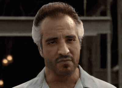 Two Men At Table With Italian Sausage Sign GIF