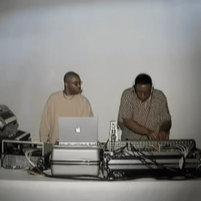 Two Men Behind Table With Apple Laptop GIF