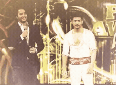 Two Men Beside Vicky Sign GIF