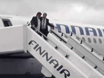 Two Men Boarding Finnair Plane On Cloudy Day GIF