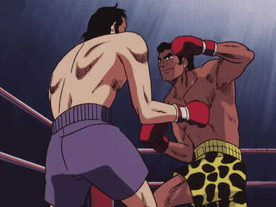 Two Men Boxing In Ring, One In Purple Shorts GIF