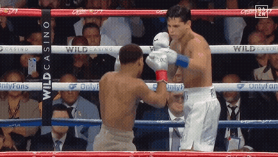 Two Men Boxing In Ring With Casino Banner GIF