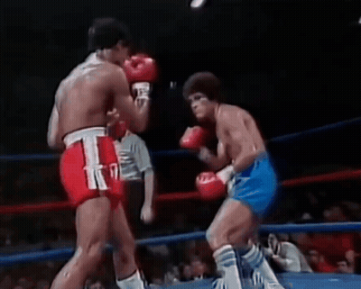 Two Men Boxing In Ring With Referee GIF