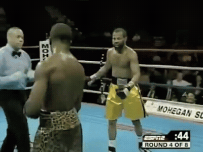 Two Men Boxing In Ring With Referee GIF