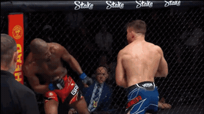 Two Men Boxing In Ring With Referee GIF