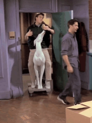 Two Men Carrying Deer Statue On Dolly GIF