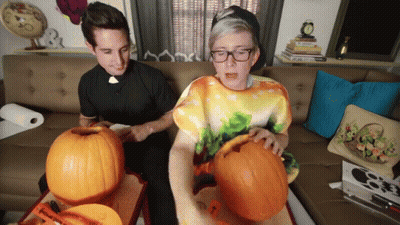 Two Men Carving Pumpkins One In Tie Dye Shirt GIF