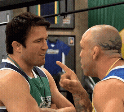 Two Men Conversing One With Head Tattoo GIF