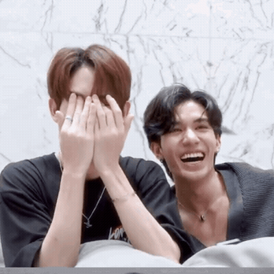 Two Men Covering Faces, One With Ring GIF