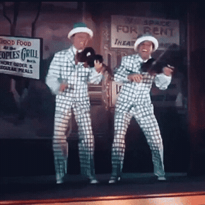 Two Men Dancing By Space For Rent Sign GIF