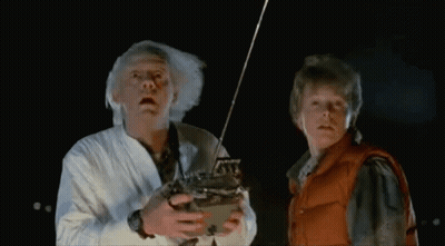 Two Men Dancing In Front Of Bob's Place Neon Sign GIF