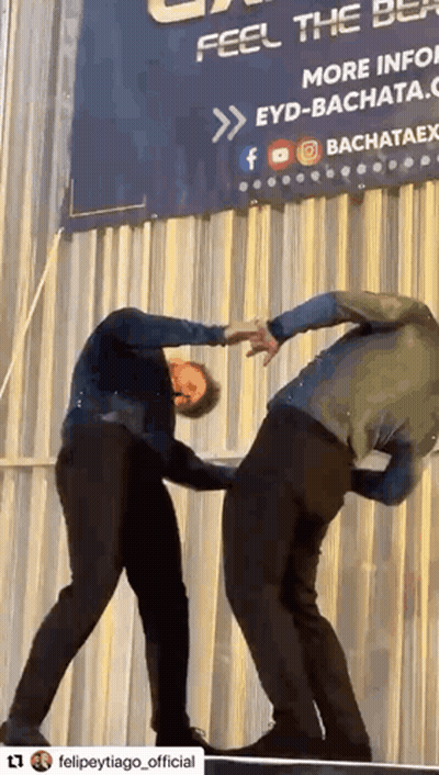 Two Men Dancing In Front Of Feel The Best Sign GIF
