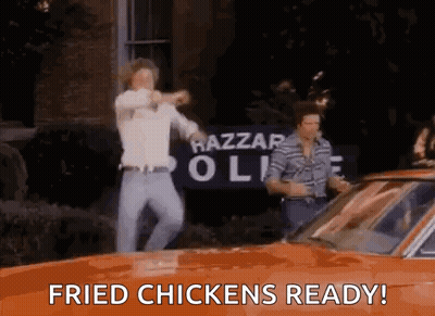 Two Men Dancing In Front Of Orange Car Saying Fried Chickens Ready GIF