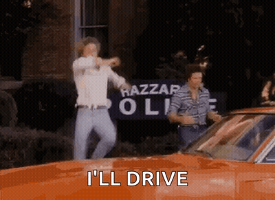 Two Men Dancing In Front Of Orange Car Saying I'll Drive GIF