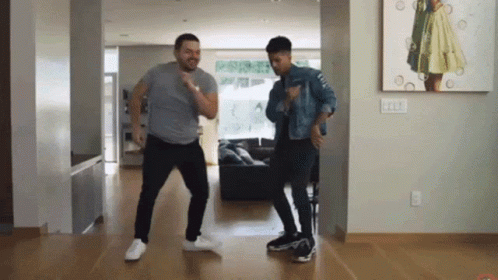 Two Men Dancing In Front Of Painting Of Woman GIF